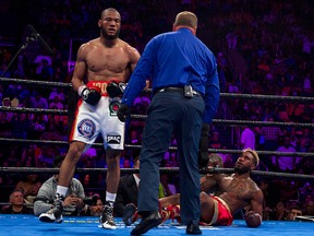 Jarrett Hurd, right, falls in the second round after a punch by Julian Williams during the IBF, WBA and IBO super welterweight title boxing bout in Fairfax, Va., Saturday, May 11, 2019.