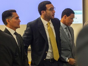 Former NFL football player Kellen Winslow Jr., centre, stands as the jury enters the courtroom on the first day of his rape trial, Monday May 20, 2019, in Vista, Calif.