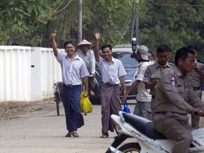Reuters journalists Wa Lone, left, and Kyaw She Oo, third left, wave as they walk out from Insein Prison after being released in Yangon, Myanmar Tuesday, May 7, 2019.