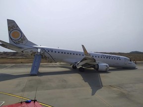 Rescue team gather near a plane of Myanmar National Airline (MNA) after an accident at Mandalay International airport Sunday, May 12, 2019, in Mandalay, Myanmar.