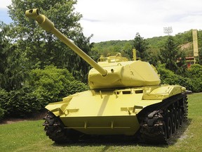 This May 20, 2019 photo shows a M-41 Bulldog tank that sits at the entrance of Bluefield's Lotito City Park that was mysteriously painted a lemon-lime green color in Bluefield, W.Va.(Eric DiNovo/The Daily Telegraph via AP)