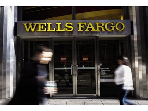 Pedestrians walk past a Wells Fargo & Co. bank branch in New York, U.S., on Thursday, Oct. 6, 2016. Wells Fargo & Co.'s senior executives should be investigated by U.S. prosecutors over the bank's unauthorized creation of customer accounts, Democrats in the U.S. Senate told Attorney General Loretta Lynch.