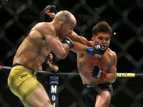 Marlon Moraes of Brazil punches Henry Cejudo in their bantamweight championship bout during the UFC 238 event at United Center on June 8, 2019 in Chicago, Illinois.