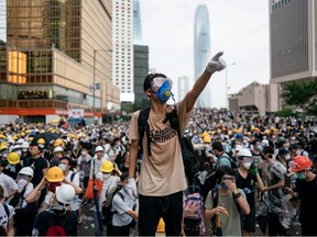 A protester makes a gesture during a protest on June 12, 2019 in Hong Kong China. Large crowds of protesters gathered in central Hong Kong as the city braced for another mass rally in a show of strength against the government over a divisive plan to allow extraditions to China.