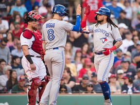 Freddy Galvis #16 celebrates with Cavan Biggio #8 of the Toronto Blue Jays after hitting a home run in the seventh inning against the Boston Red Sox at Fenway Park on June 22, 2019 in Boston, Massachusetts. (Photo by Kathryn Riley /Getty Images)