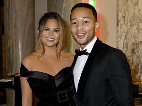 : John Legend and Chrissy Teigen attend Pianists Lang Lang & Gina Alice Cocktail Wedding at Hotel Shangri-La on June 02, 2019 in Paris, France.