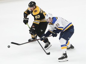 Brad Marchand, right, of the Bruins and Tyler Bozak of the Blues battle for the puck during the third period in Game 5 on Thursday night.