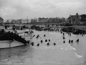 View looking east along 'Nan White' Beach, showing Canadian soldiers on D-Day, June 6, 1944. Archives of Canada-Gilbert Alexandre Milne )