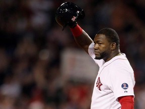 Boston Red Sox designated hitter David Ortiz stands safe at second base and salutes the crowd after hitting his 2000th career hit in the sixth inning against the Detroit Tigers during their MLB American League Baseball game in Boston, Sept. 4, 2013.