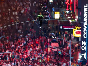 Aerialist Nik Wallenda walks the highwire with his sister Lijana (unseen) over Times Square in New York, U.S., June 23, 2019.  REUTERS/Eduardo Munoz