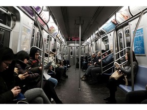 People ride on the subway on January 10, 2018 in New York City.