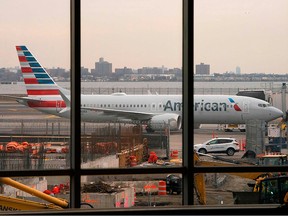 In this file photo taken on March 13, 2019 an American Airlines 737 Max sits at the gate at LaGuardia airport in New York.