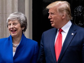 US President Donald Trump (R) and Britain's Prime Minister Theresa May (L) gesture as they pose in front of the door of 10 Downing Street in London on June 4, 2019.