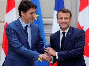 French President Emmanuel Macron shakes hands with Canadian Prime Minister Justin Trudeau during a press conference at the Elysee Palace in Paris, June 7, 2019.