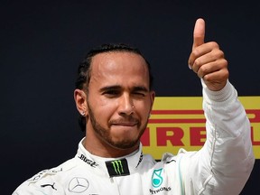 Winner Mercedes' British driver Lewis Hamilton celebrates on the podium after the Formula One Grand Prix de France at the Circuit Paul Ricard in Le Castellet, southern France, on June 23, 2019.