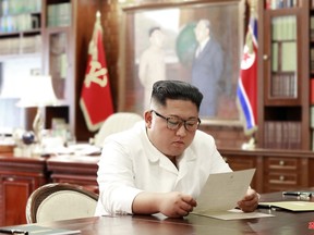 This file undated and unlocated picture released from North Korea's official Korean Central News Agency (KCNA) on June 23, 2019 shows North Korean leader Kim Jong Un reading a personal letter from U.S. President Donald Trump. (KCNA VIA KNS/AFP/Getty Images)