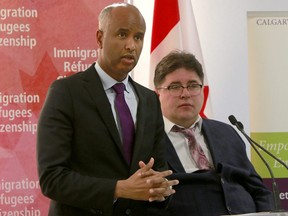 Minister of Immigration, Refugees and Citizenship  Ahmed Hussen, speaks with Liberal MLA Kent Hehr at a press conference  in Calgary on Jan. 4, 2019.