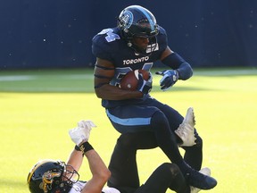 Argonauts’ Llevi Noel (top) makes a catch against Tiger-Cats’ Mike Daly on Saturday. The Argos see their next action on Monday against the Riders. Jack Boland/Toronto Sun