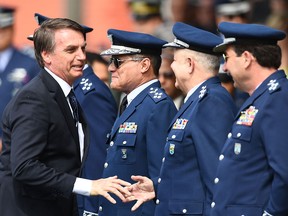 Brazilian President Jair Bolsonaro greets generals during the ceremony in which Lieutenant-Brigadier Antonio Carlos Moretti takes the helm of the Brazilian Air Force, at Brasilia's Air Base on January 4, 2019. (EVARISTO SA/AFP/Getty Images)