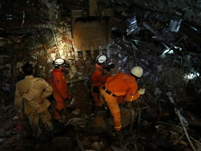 A rescue team attempts to find missing workers at a collapsed building in Sihanoukville, Cambodia, on Saturday, June 22, 2019.