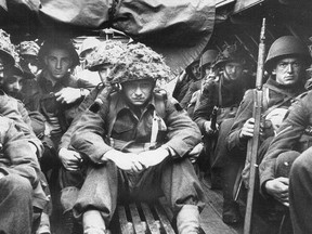 Canadian troops sit stoically in assault craft mere minutes before landing on Juno Beach the morning of D-Day, June 6, 1944.