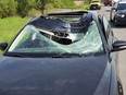 A vehicle is damaged on Hwy. 400 at Hwy. 89 after being hit by a bouncing wheel on Wednesday, June 12, 2019.