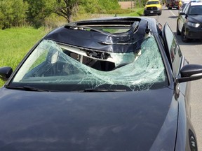 A vehicle is damaged on Hwy. 400 at Hwy. 89 after being hit by a bouncing wheel on Wednesday, June 12, 2019.