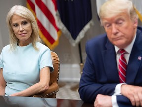 U.S. President Donald Trump sits alongside Kellyanne Conway (L), counselor to the president, during a meeting on the opioid epidemic in the Roosevelt Room of the White House in Washington, D.C., June 12, 2019.