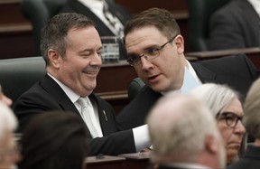Alberta Premier Jason Kenney and Jason Nixon, Minister of Environment and Parks, chat before the speech from the throne is delivered in Edmonton Alta, on Tuesday May 21, 2019.