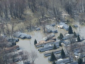 A dike where waters of the Lake of Two Mountains broke through is seen in Ste-Marthe-sur-le-Lac, Que., on April 30, 2019. Police say a man who allegedly drove his vehicle into an office that was helping flood victims will face charges of dangerous driving and assault with a weapon. No one was injured when the vehicle slammed into the office late Wednesday in Ste-Marthe-sur-le-Lac, northwest of Montreal.