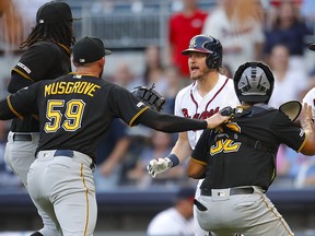 Josh Donaldson of the Atlanta Braves is restrained after being hit by a pitch as he charges Joe Musgrove of the Pittsburgh Pirates at SunTrust Park on June 10, 2019 in Atlanta. (Todd Kirkland/Getty Images)