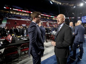 Toronto Maple Leafs GM Kyle Dubas (left) speaks with Columbus Blue Jackets counterpart Jarmo Kekalainen at the NHL draft at Rogers Arena in Vancouver on Saturday. (Bruce Bennett/Getty Images)