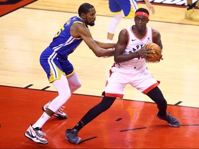 Kevin Durant (left) of the Golden State Warriors guards Pascal Siakam of the Toronto Raptors during Game 5 of the NBA Finals in Toronto on Monday night. (Vaughn Ridley/Getty Images)