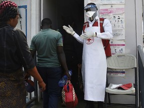 A health worker receives people at the Mpondwe Health Screening Facility in the Uganda border town with the Democratic Republic of Congo, on June 13, 2019.