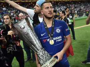 In this file photo taken on May 30, 2019 Chelsea midfielder Eden Hazard holds the trophy after winning the UEFA Europa League final at the Baku Olympic Stadium in Baku, Azerbaijian. (OZAN KOSE/AFP/Getty Images)
