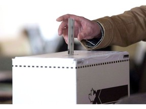 A voter casts a ballot in the 2011 federal election in Toronto on May 2, 2011.