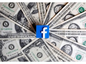 A 3-D printed Facebook logo is seen on U.S. dollar banknotes in this illustration picture, June 18, 2019.