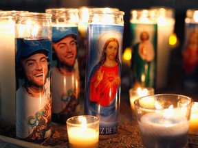 LOS ANGELES, CA - SEPTEMBER 08:  Candles form a memorial to late rapper Mac Miller at the corner of Fairfax and Melrose Avenues on September 8, 2018 in Los Angeles, California. Miller died of a suspected overdose on Friday, September 7.