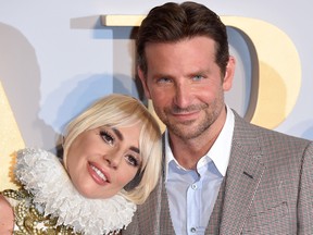 American singer and actress Lady Gaga (L) and American actor and filmmaker Bradley Cooper pose on the red carpet upon arrival for the UK premiere of the film "A Star is Born" in central London on September 27, 2018.