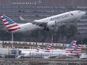 A Boeing 737 MAX flown by American Airlines passes by the Lockheed Martin building as it takes off from Ronald Reagan Washington National Airport in Arlington, Va., on March 11, 2019. (ANDREW CABALLERO-REYNOLDS/AFP/Getty Images)
