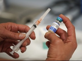 SALT LAKE CITY, UT - APRIL 26: In this photo illustration a one dose bottle of measles, mumps and rubella virus vaccine, made by MERCK, is held up at the Salt Lake County Health Department on April 26, 2019 in Salt Lake City, Utah.
