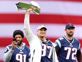 Former New England Patriots player Rob Gronkowski raises the Lombardi Trophy over his head before the Red Sox home opening game against the Toronto Blue Jays at Fenway Park on April 9, 2019 in Boston. (Maddie Meyer/Getty Images)