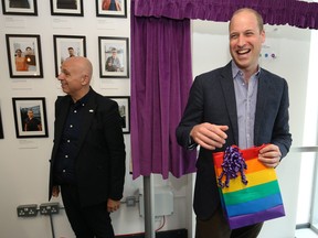 Prince William, Duke of Cambridge, receives a gift bag from trust chief executive officer Tim Sigsworth as he visits the Albert Kennedy Trust to learn about the issue of LGBTQ youth homelessness and the unique approach that the organization is taking to tackling the problem on June 26, 2019 in London. (Jonathan Brady - WPA Pool/Getty Images)