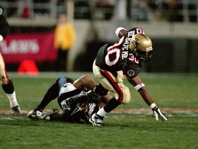 Rod Smart of the Las Vegas Outlaws gets tackled during the game against the New York/New Jersey Hitmen at the Sam Boyd Stadium in Las Vegas, Nevada. The Outlaws defeated the Hitmen 19-0.