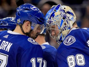 TAMPA, FL - APRIL 14: Andrei Vasilevskiy #88 and Alex Killorn #17 of the Tampa Bay Lightning celebrate winning Game Two of the Eastern Conference First Round  during the 2018 NHL Stanley Cup Playoffs at Amalie Arena on April 14, 2018 in Tampa, Florida.