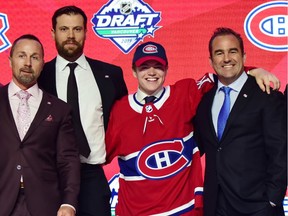 Canadiens draft pick Cole Caufield, second from right, poses with assistant GM Trevor Timmins, left, captain Shea Weber and owner Geoff Molson after being selected 15th overall Friday night in Vancouver.