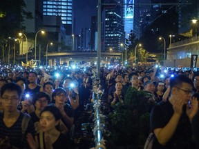 Protesters hold up their phones with lights on during a mass rally June 16, 2019, to protest against a controversial extradition bill that would allow suspected criminals to be sent from Hong Kong to mainland China for trial.