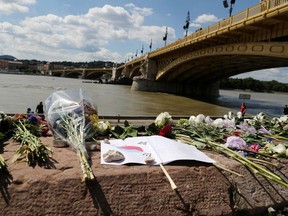 Flowers are seen placed next to the Margaret bridge in respect for the victims from a boat carrying South Korean tourists capsized on the Danube river, in Budapest, Hungary, June 1, 2019. REUTERS/Marko Djurica ORG XMIT: MDJ04