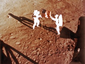 In this file photo taken on July 20, 1969 US astronauts Neil Armstrong and "Buzz" Aldrin deploy the U.S. flag on the lunar surface during the Apollo 11 lunar landing mission. (HANDOUT/AFP/Getty Images)