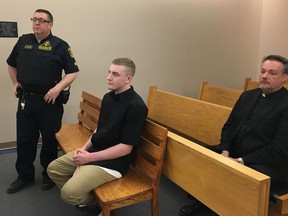 Lucas Dawe, centre, appears in provincial court in St. John's on Wednesday June 19, 2019. Sentencing arguments are expected to be heard today for a Newfoundland man convicted in the bizarre case of skeletal remains stolen from an Anglican cemetery.Lucas Dawe, 20, pleaded guilty to a charge of interfering with human remains in St. John's provincial court last month.